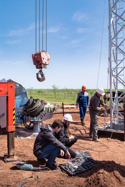 Orenburg, Russia - May, 26, 2020: Installation of a wind turbine. Workers and engineers, construction machinery on a construction site
